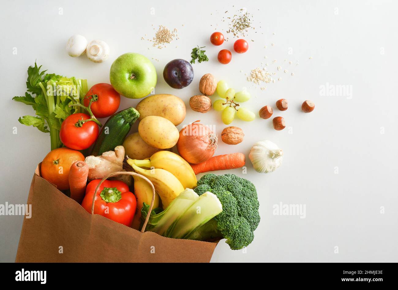 Recyclable shopping bag with fruits and vegetables on white table. Top