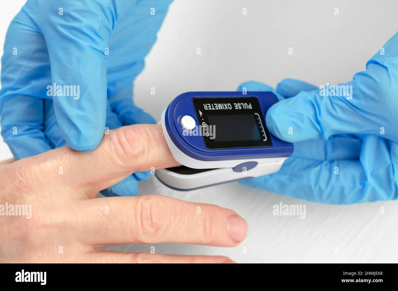 Measurement of saturation in a 60-year-old woman. The hands of a doctor ...