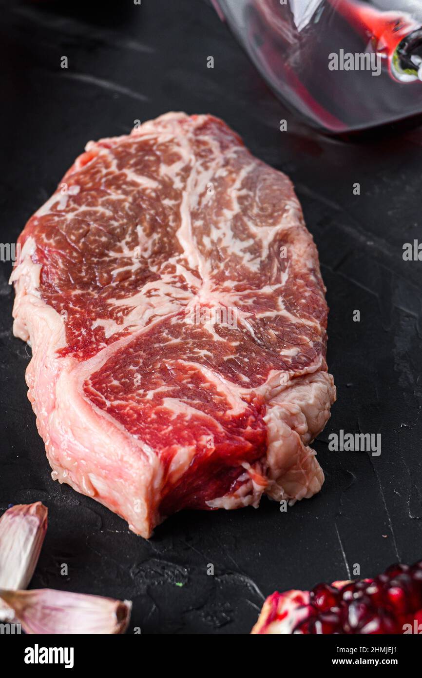 Flat Iron beef steak cuts, with herbs, seasoning on black table, side view Stock Photo Alamy