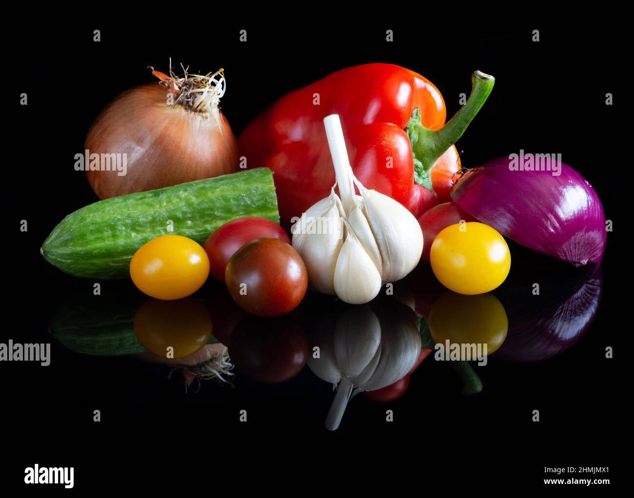 Different vegetables on reflective black background Stock Photo