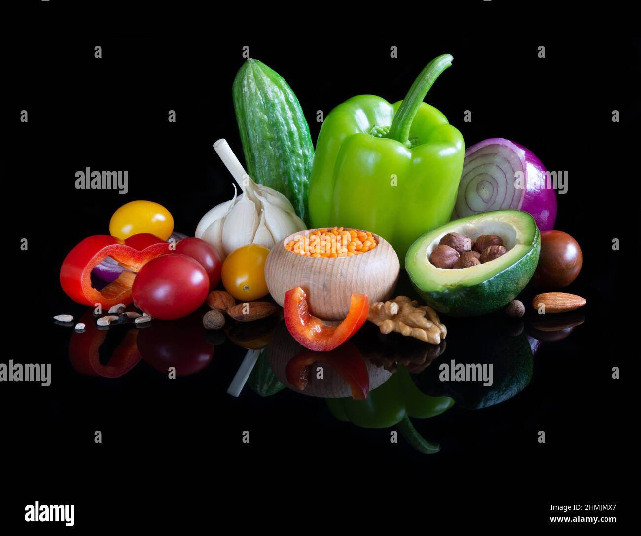 Different vegetables on reflective black background Stock Photo