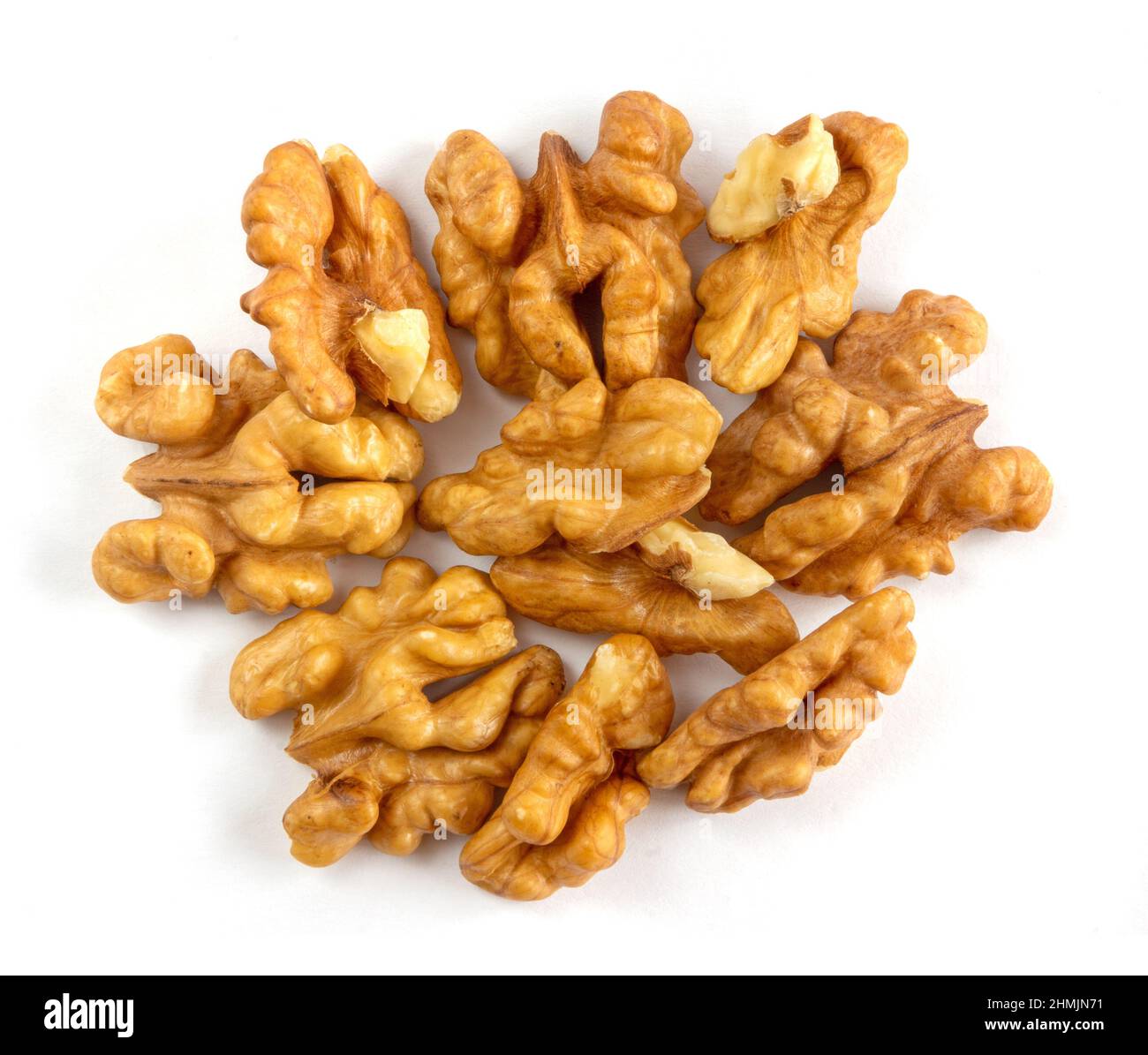 Cracked walnuts cores on white background Stock Photo