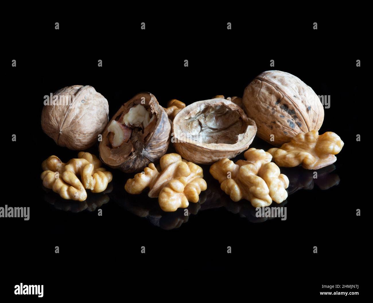 Walnuts on black reflective background Stock Photo