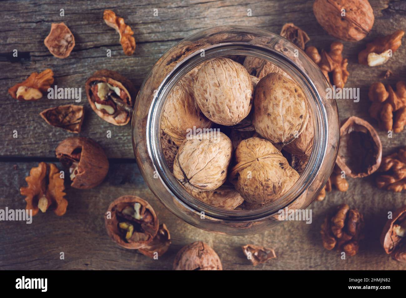 Whole solid walnuts in a jar top view Stock Photo