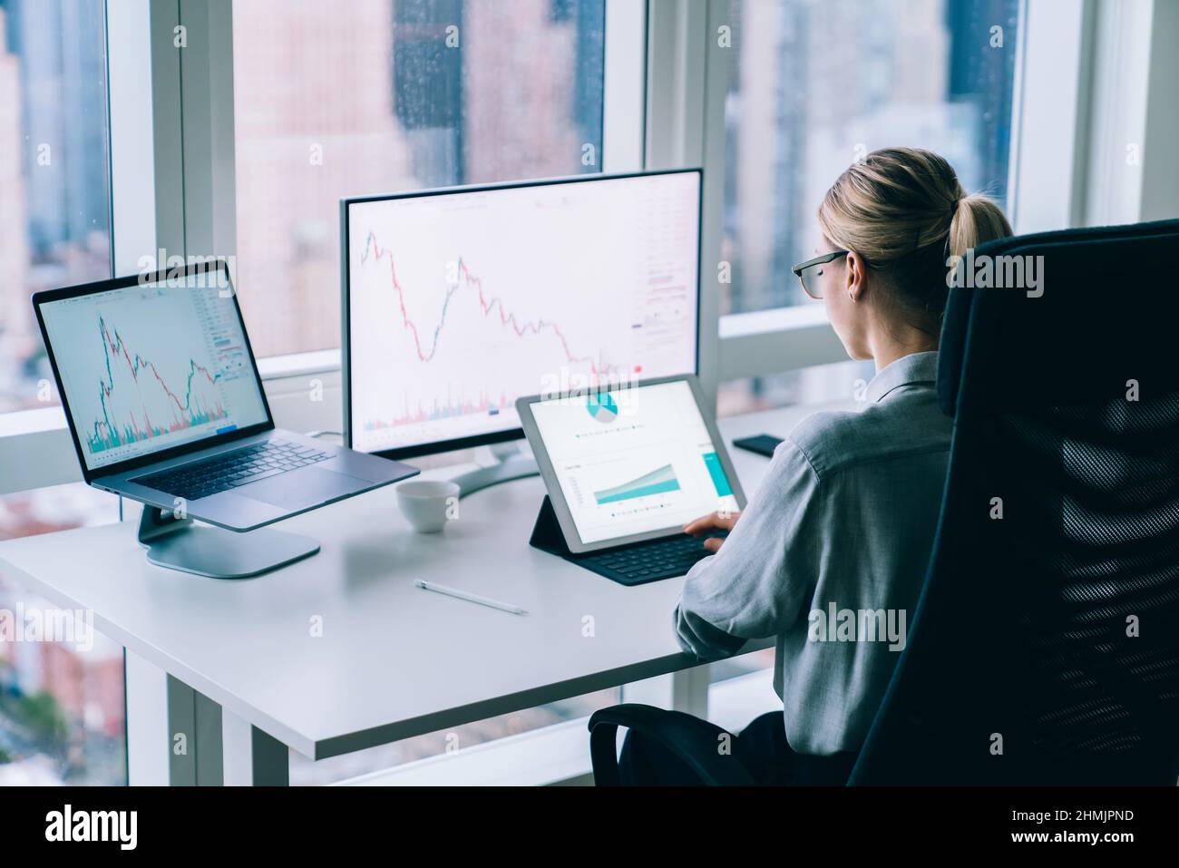 Faceless woman analyzing charts in office Stock Photo