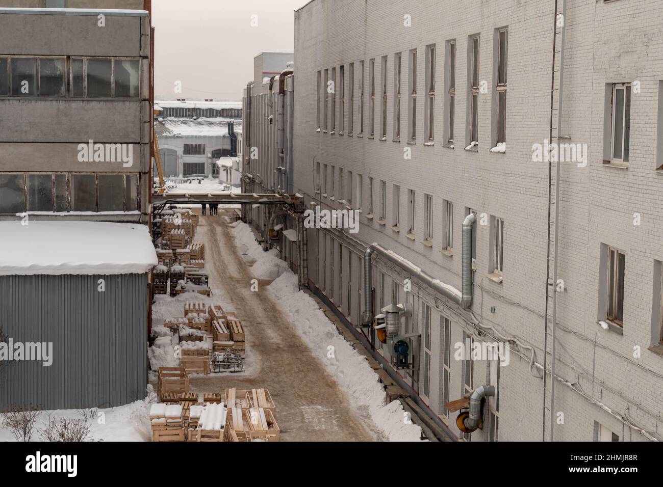 Road between buildings in winter 2022 Stock Photo