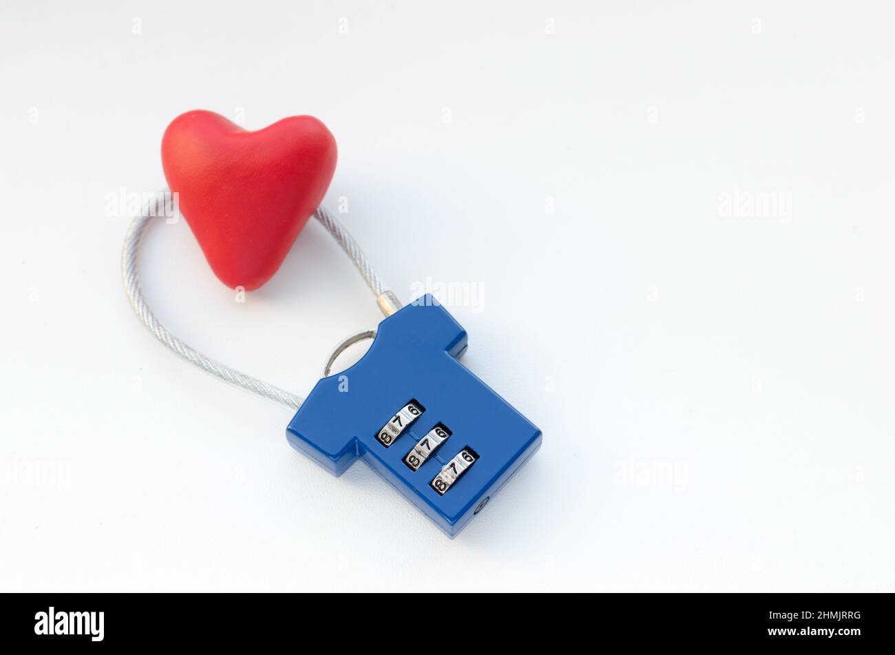 Red heart on a blue combination lock on white background Stock Photo
