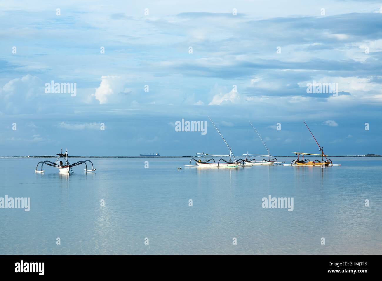 Fishing boats floating on the ocean. Wooden boat sailing in open waters. Sailing boat landscape. Tropical scenery. Bali island, Indonesia. Summer vaca Stock Photo