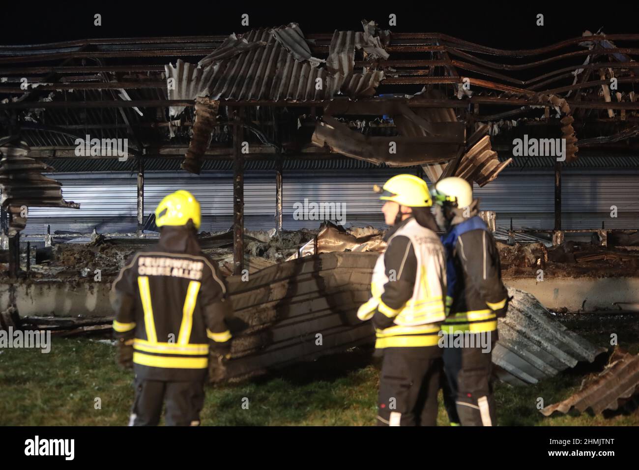 Wackersleben, Germany. 10th Feb, 2022. Firefighters stand in front of