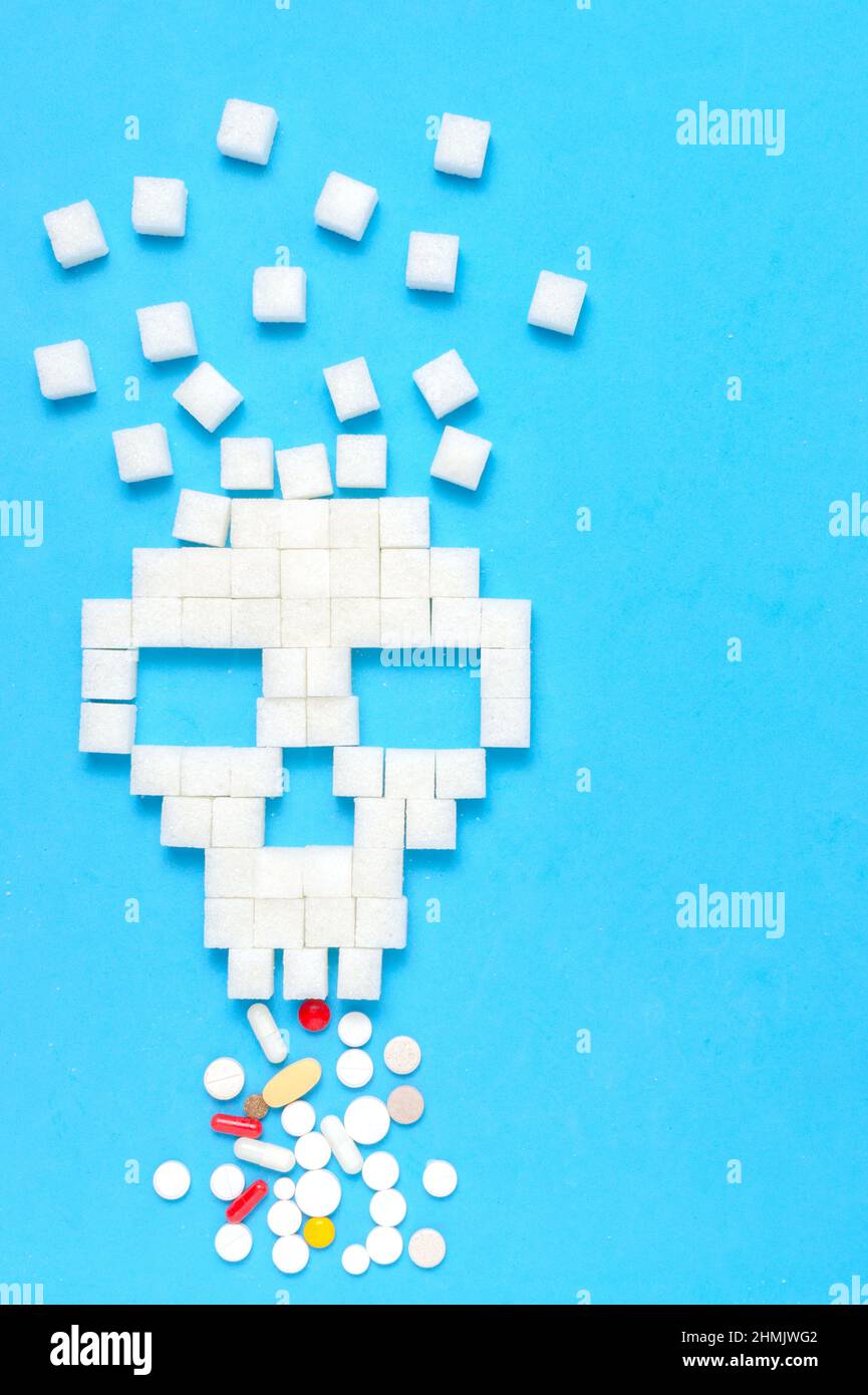 Refined sugar in form of skull with tablets and pills.The concept of healthy eating. Stock Photo