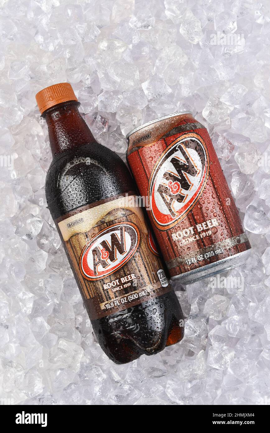 IRVINE, CALIFORNIA - 30 JAN 2022: A bottle and can of A and W root beer in a bed of crushed ice, vertical composition. Stock Photo