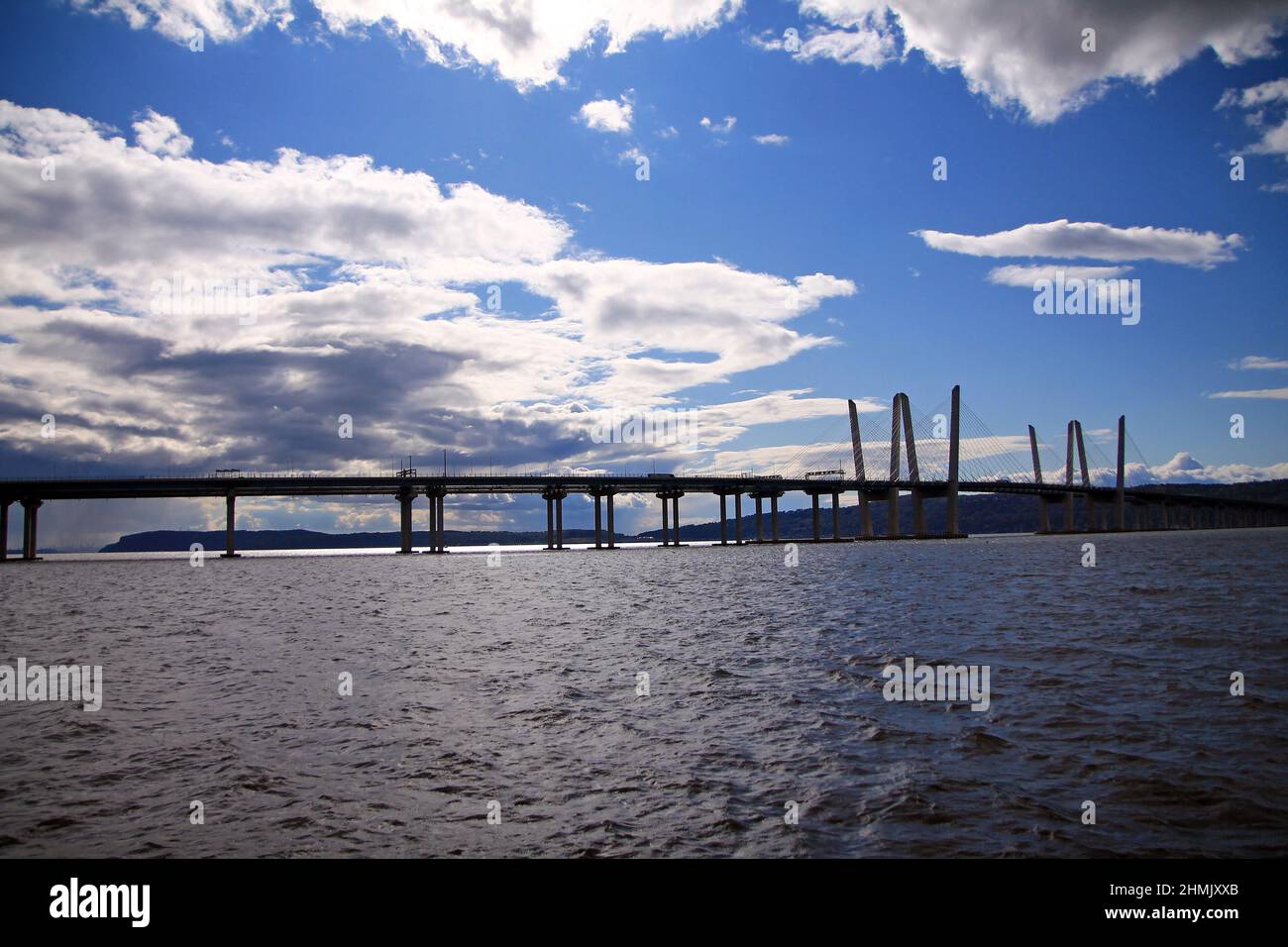 The long Governator Cuomo Bridge with clouds and blue sky on the Hudson river in the New York State Stock Photo