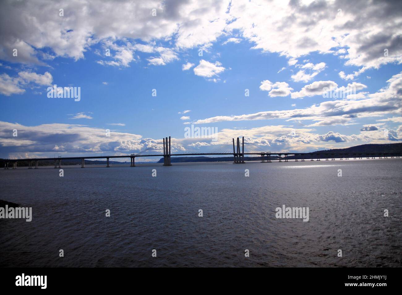 Dramatic picture of the Governator Cuomo bridge with blue sky and white clouds on the Hudson River in the New York State Stock Photo
