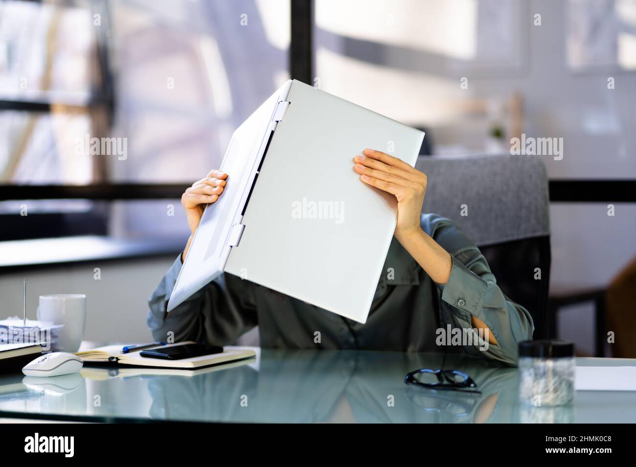 Tired Unhappy African Business Woman Hiding Under Laptop Stock Photo