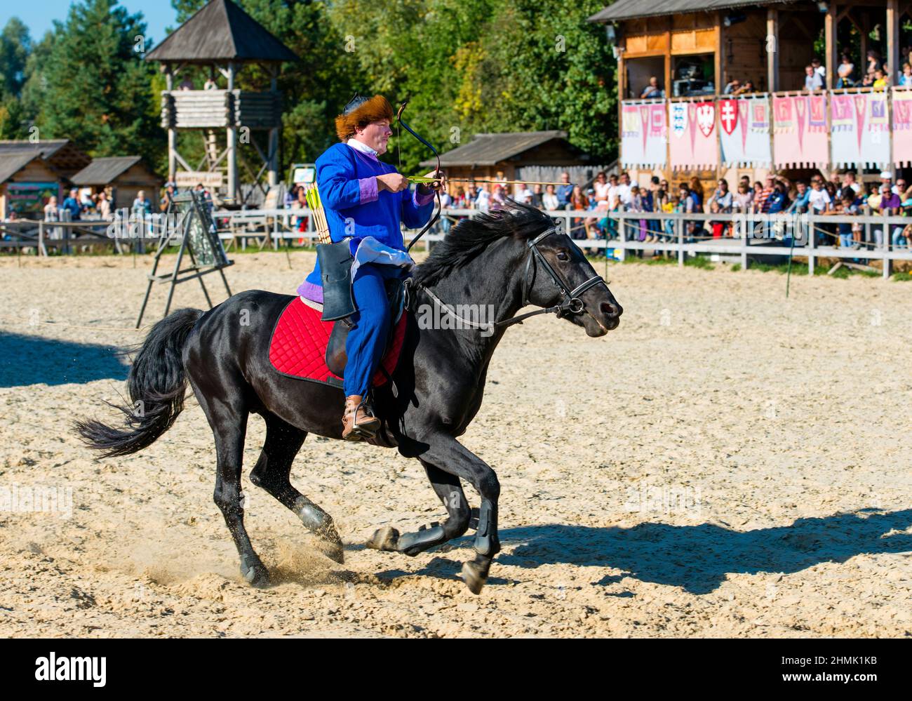 Mongol on black horse.  The Mongol rides on black horse on the stadium. Stock Photo