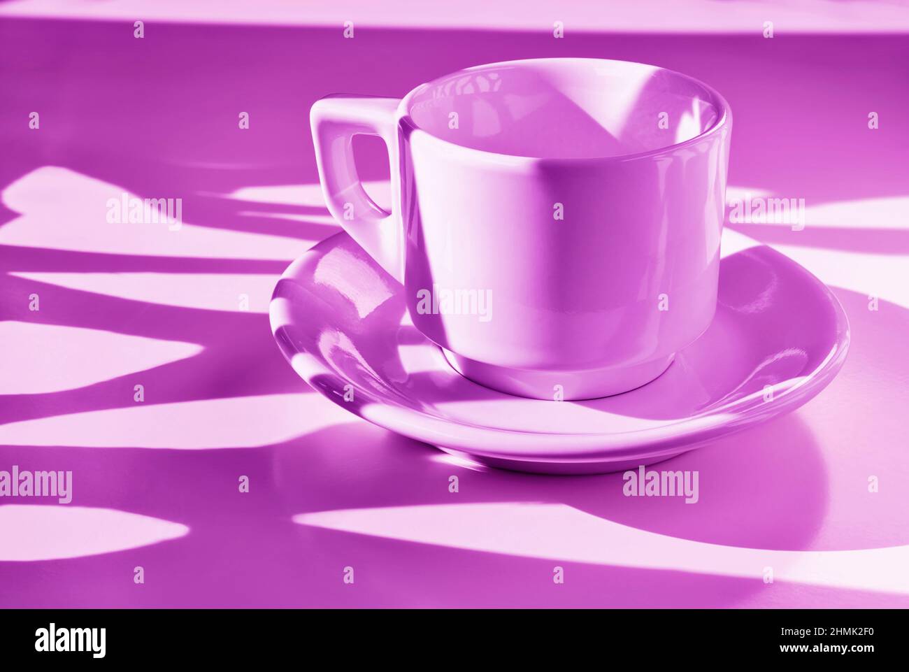 White cup of coffee on pink background ,  long shadows on cup , break time Stock Photo