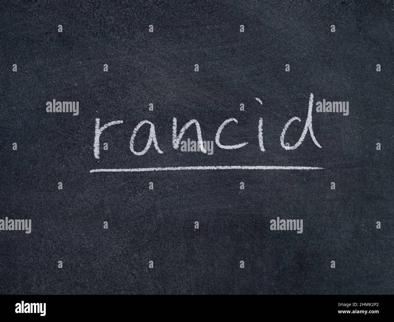 rancid concept word on blackboard background Stock Photo