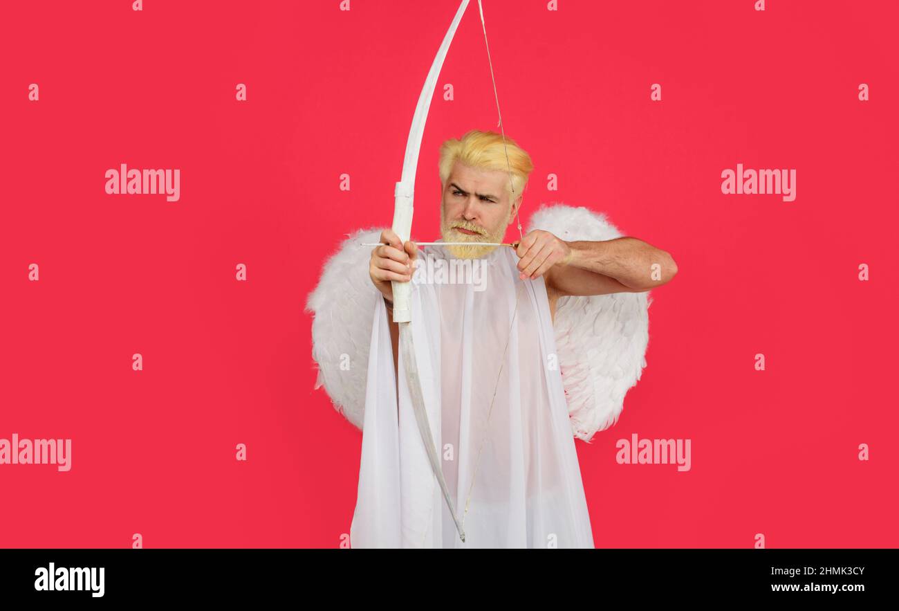Cupid shot with bow and arrow. Happy Valentines Day. Serious man in angel wings. Amour. God of love. Stock Photo