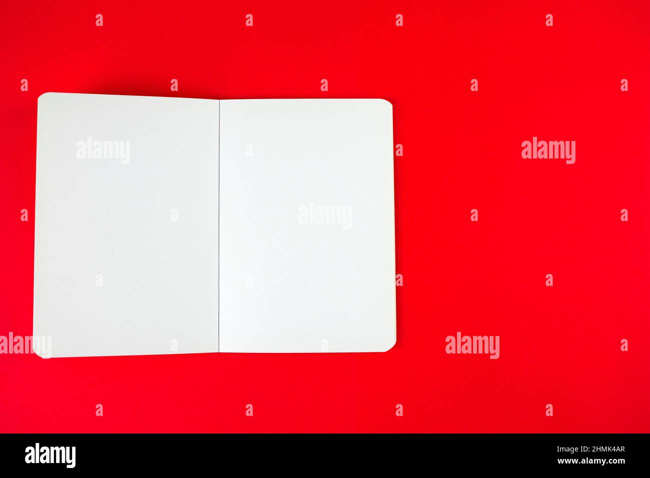 Empty blank paper notebook or book mockup on red background. White empty paper notepad Stock Photo