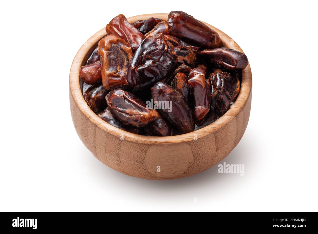 Dried dates in woodem bowl isolated on a white background Stock Photo