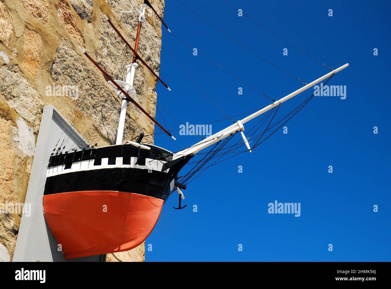 The bow of a ship extends out of a stone wall at the Woods Hole Oceanographic Institute on Cape Cod Stock Photo