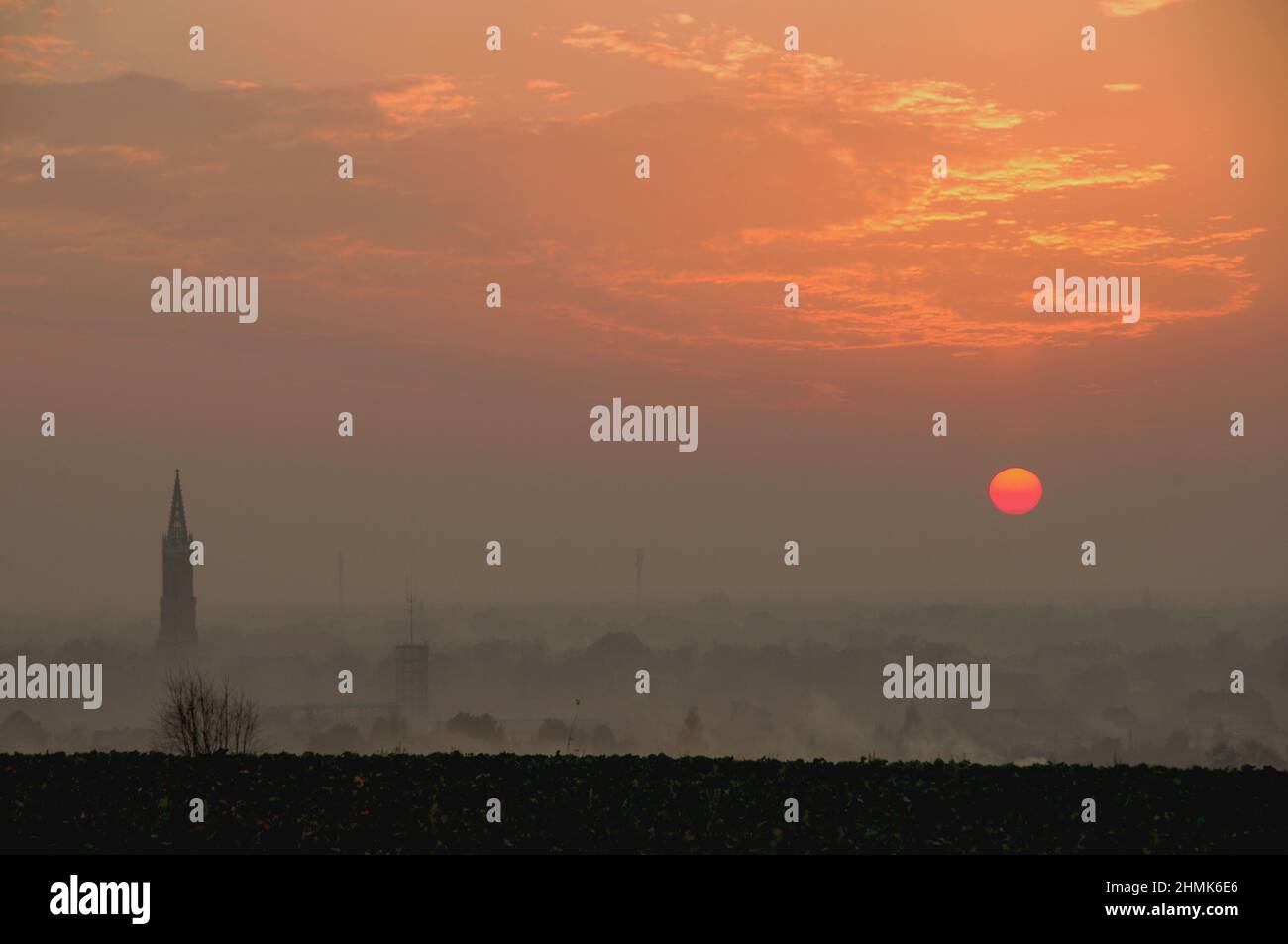Sunset over the city shrouded in smog. Stock Photo