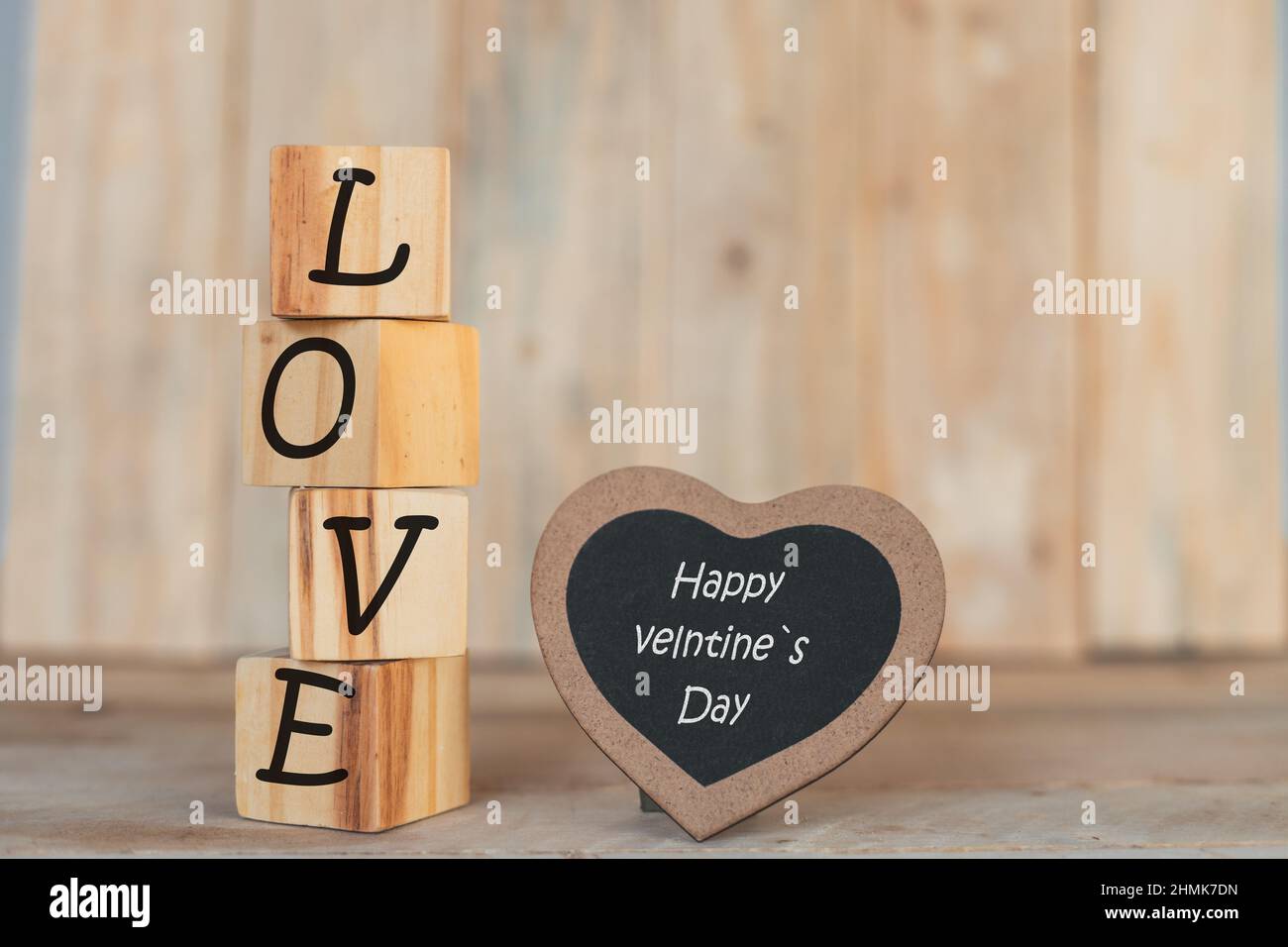 wooden blocks in vertical with the word I love you and a blackboard heart with the phrase Stock Photo