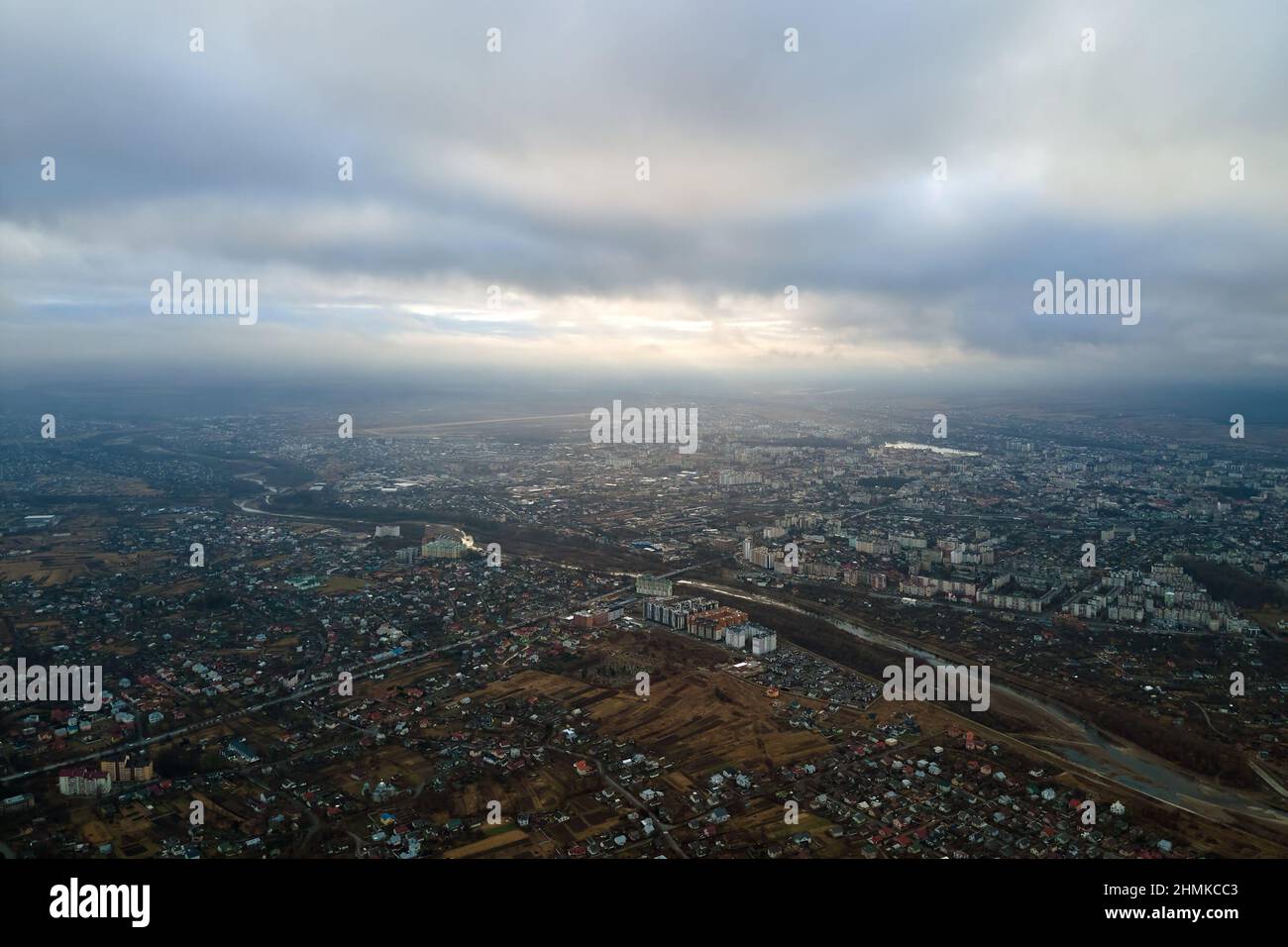Picture of Aerial view of rural homes and distant high rise apartment buildings in ...
