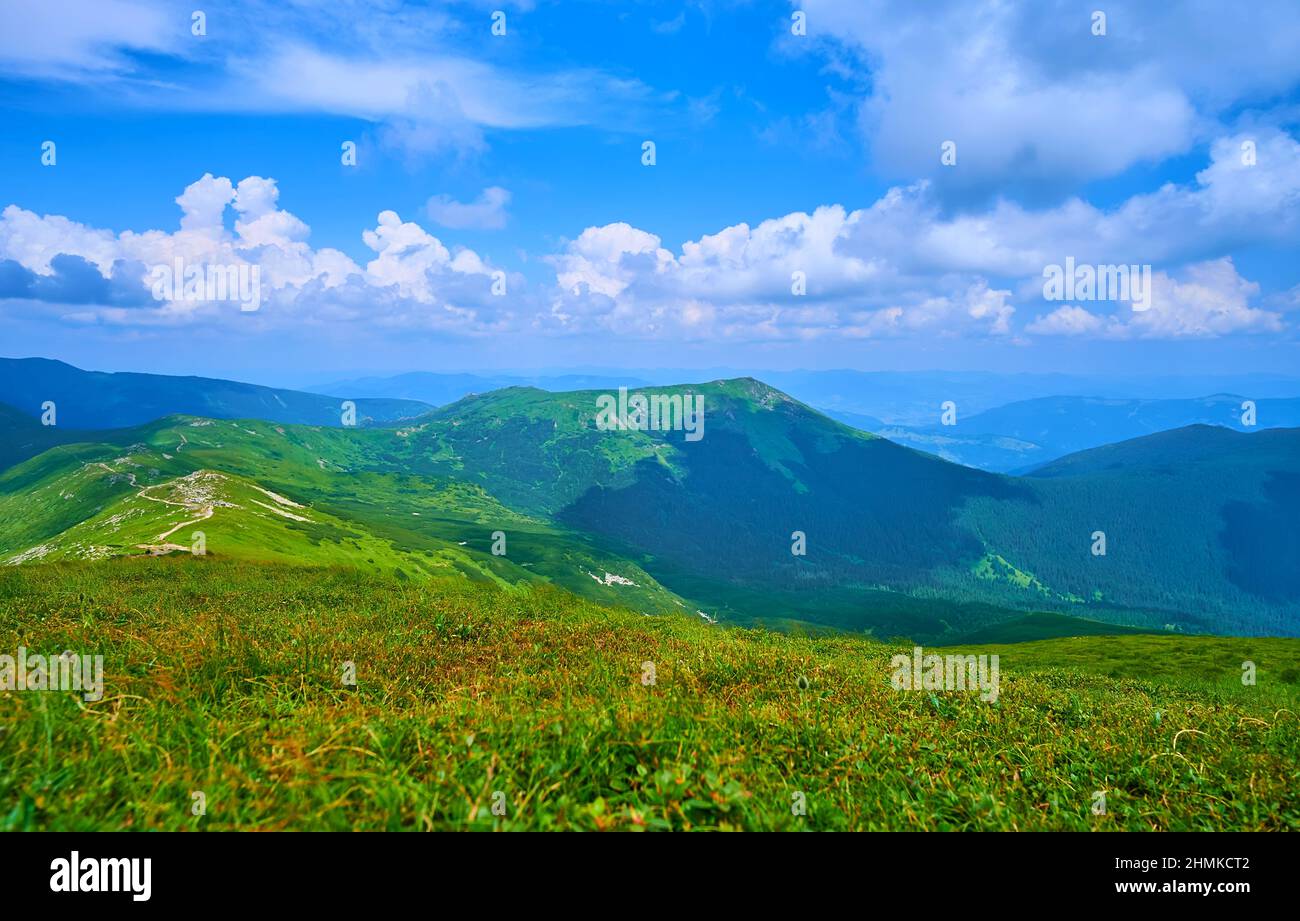 The view from the peak of Pip Ivan Mount on the Smotrych mountain and fast running white clouds in the blue skies, Chornohora Range, Carpathians, Ukra Stock Photo