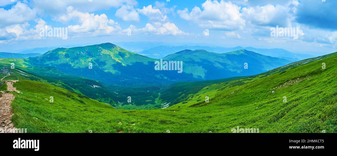 The Mount Pip Ivan slope overlooks impressive landscape of Chornohora Mountain Range with green slopes and fast running clouds above the land, Carpath Stock Photo