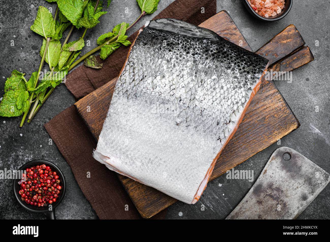 Big piece of Raw cut salmon fish set, on black dark stone table ...
