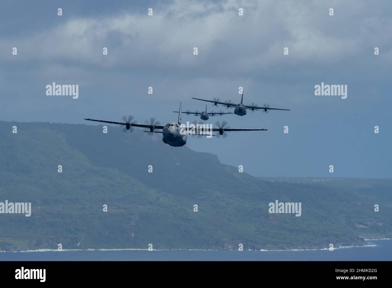 Three C-130J Super Hercules fly during exercise Cope North 22 over Tinian in the Northern Mariana Islands, Feb. 5, 2022. Air Forces from different countries including; Australia, Japan, and the U.S. take part in the yearly interactive field training exercise known as Cope North. Alliances and partnerships are crucial to our strategy, providing a durable, asymmetric strategic advantage.  (U.S. Air Force photo by Airman 1st Class Josiah Brown) Stock Photo