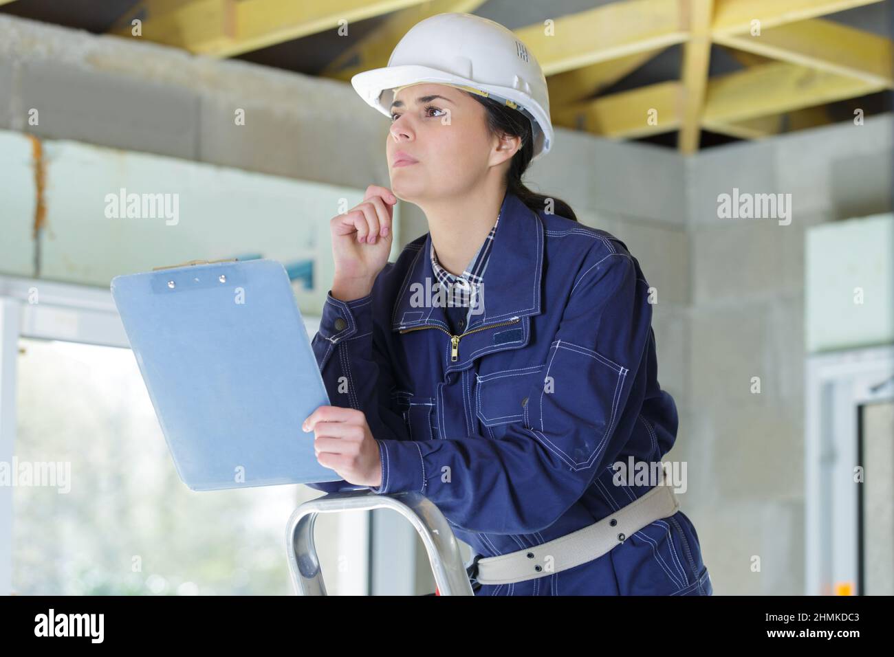 female surveyor in hard hat during house inspection Stock Photo Alamy
