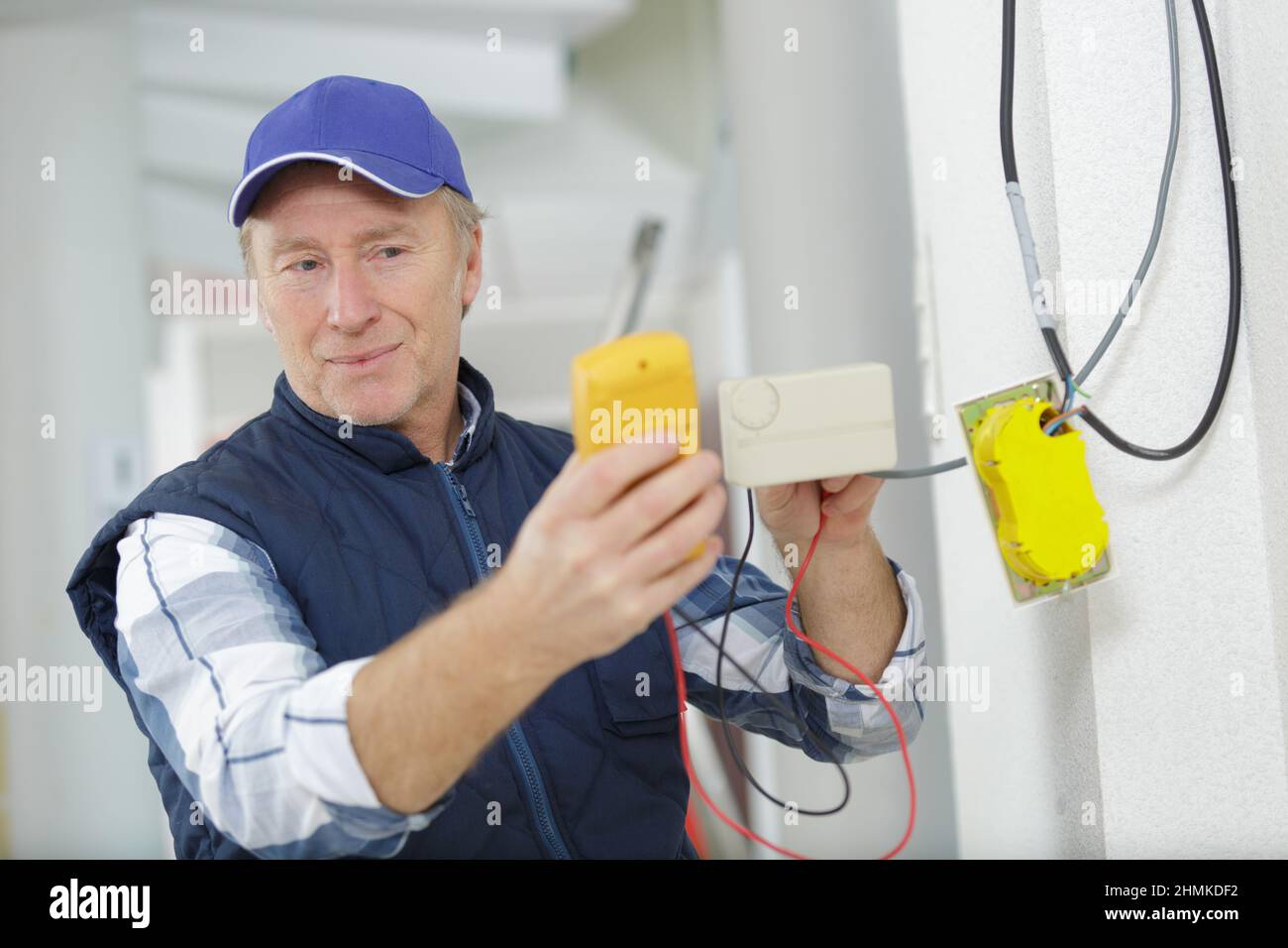 experienced electrician doing electrical work with high precision and neatness Stock Photo