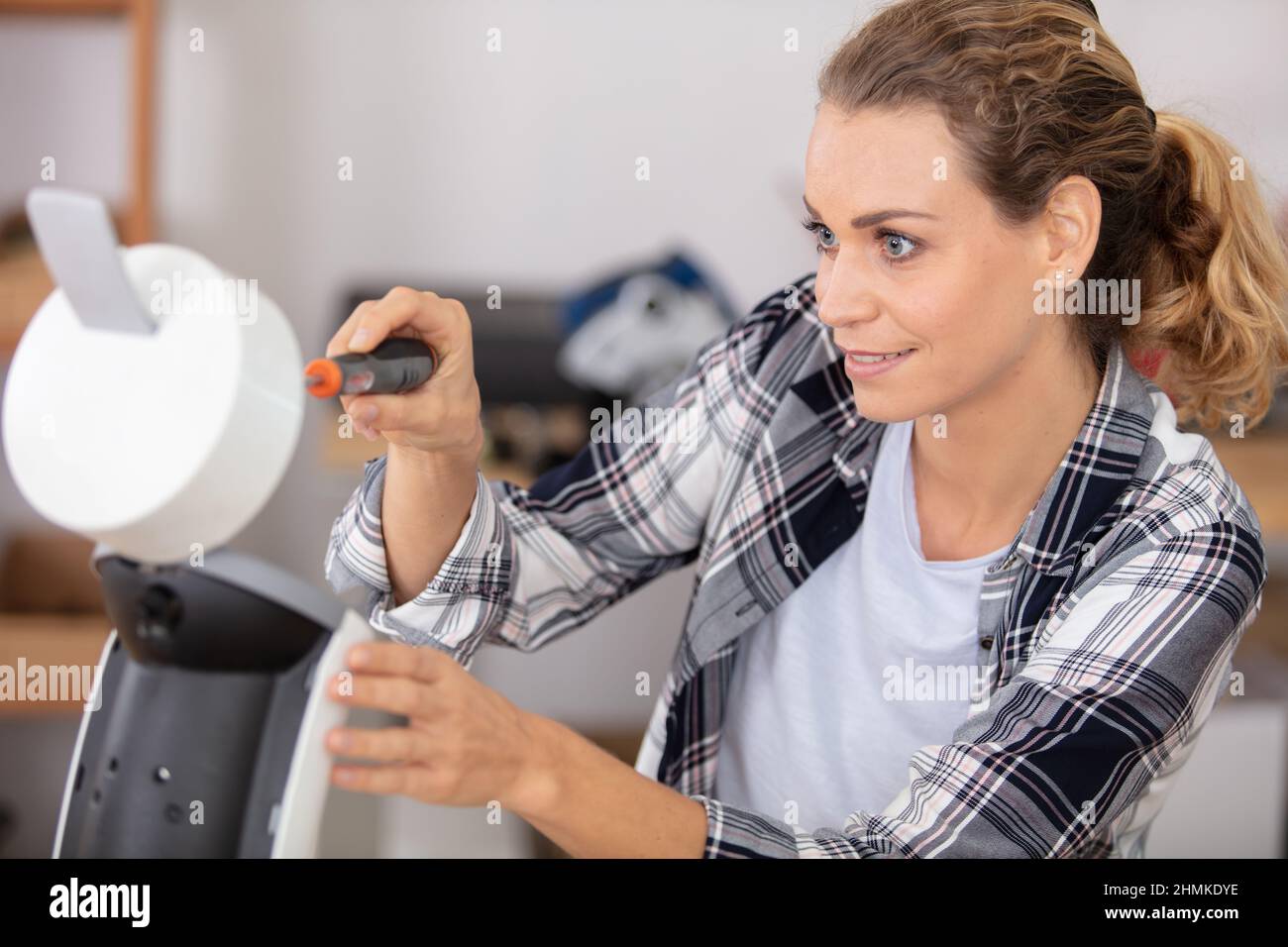 female technician repairing broken coffee machine Stock Photo Alamy