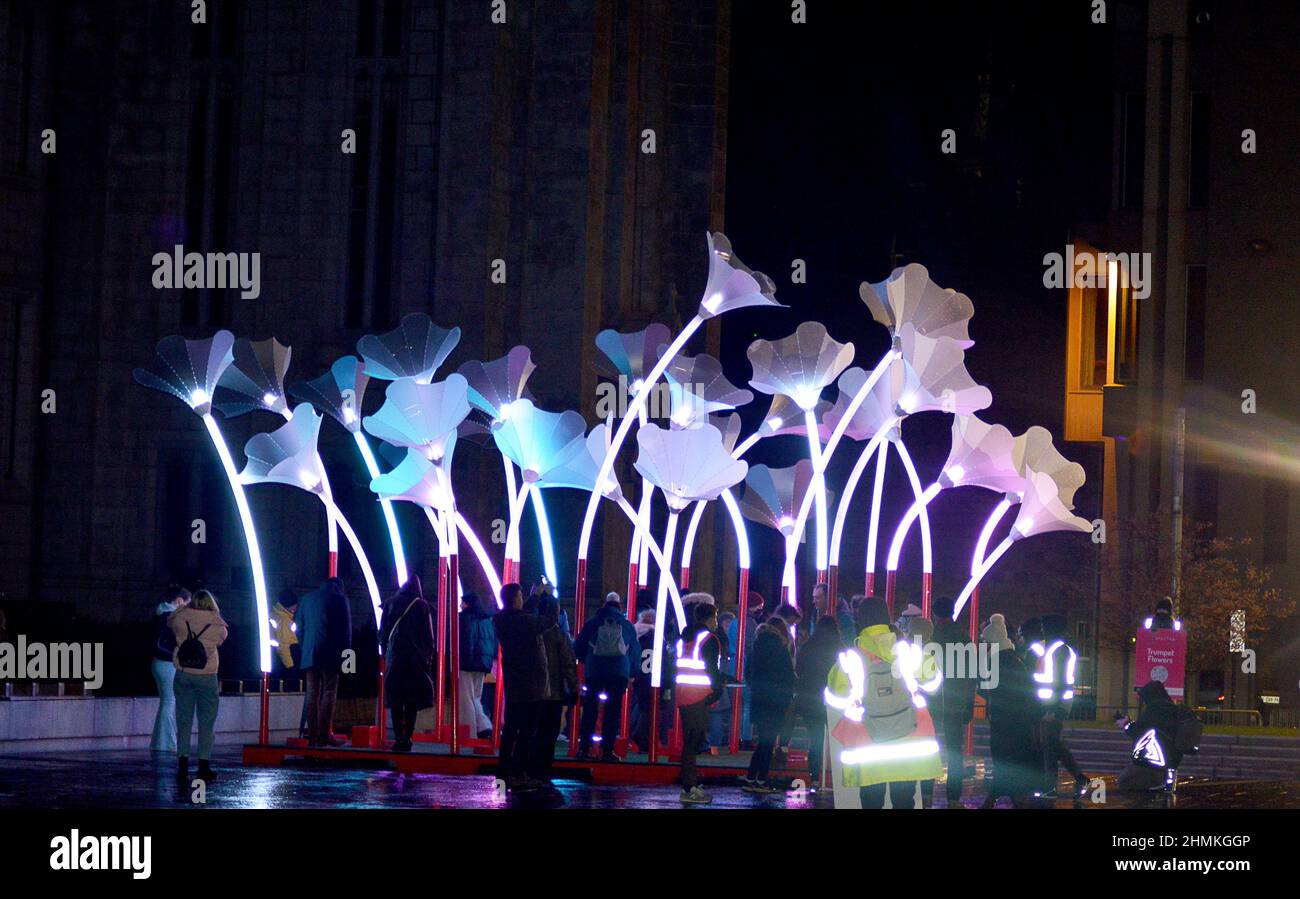 ABERDEEN, SCOTLAND - 10 FEBRUARY 2022: Scottish premiere of Trumpet Flowers by amigo & amigo where participants can make their own music by jumping around the giant musical garden in front of Marischal College as part of the Spectra festival. 10-13 February, 2022. Stock Photo