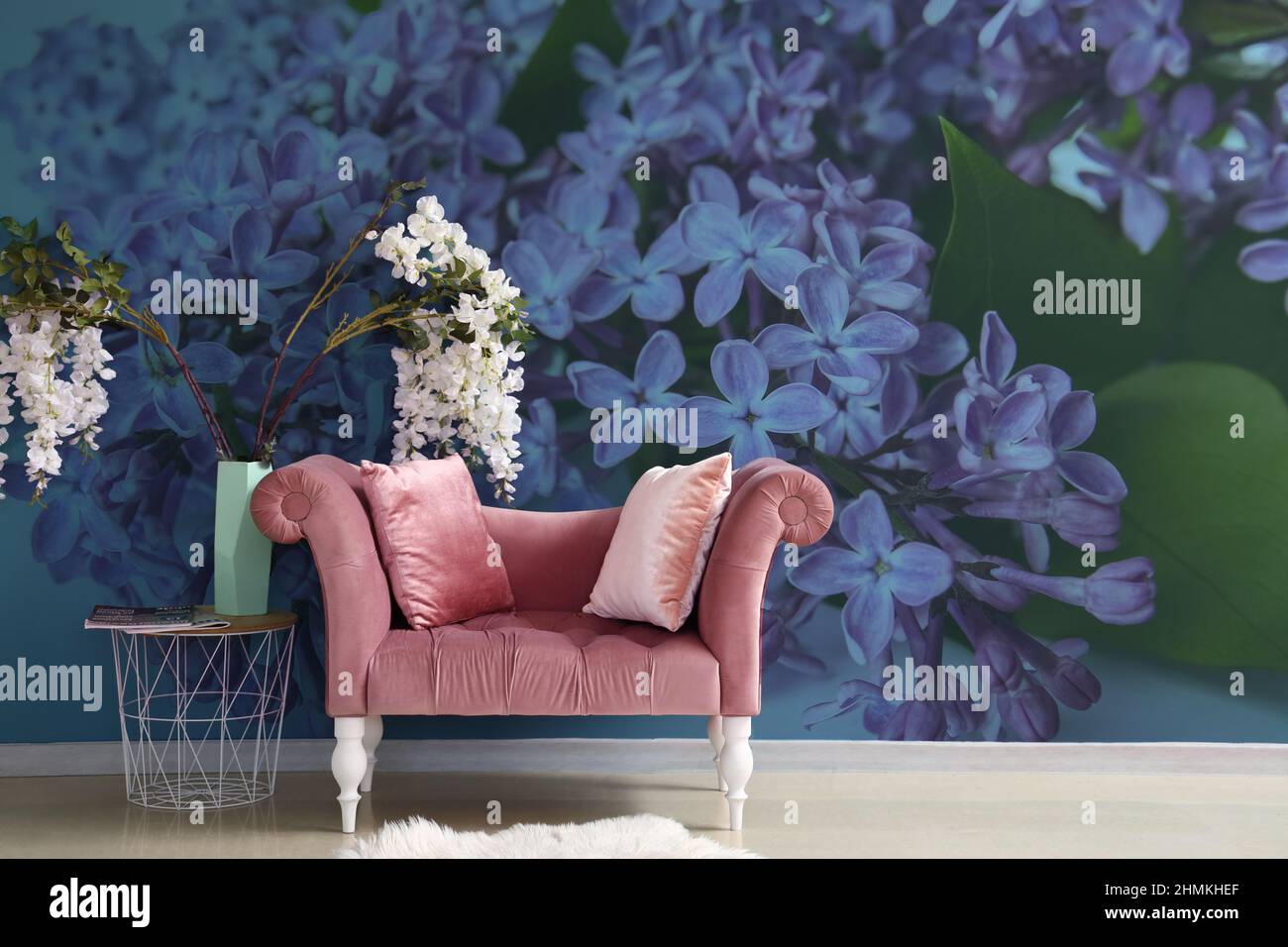 Stylish interior of room with beautiful lilac flowers on wall Stock ...