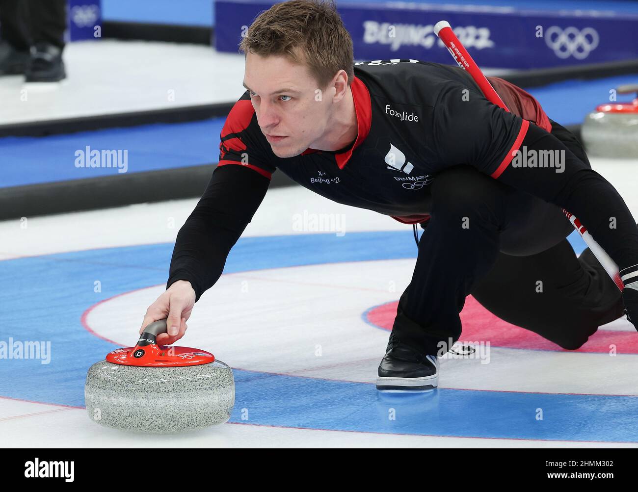 Beijing, China. 11th Feb, 2022. Mikkel Krause of Denmark competes during the curling men's round robin session 3 of Beijing 2022 Winter Olympics between China and Denmark at National Aquatics Centre in Beijing, capital of China, Feb. 11, 2022. Credit: Cao Can/Xinhua/Alamy Live News Stock Photo