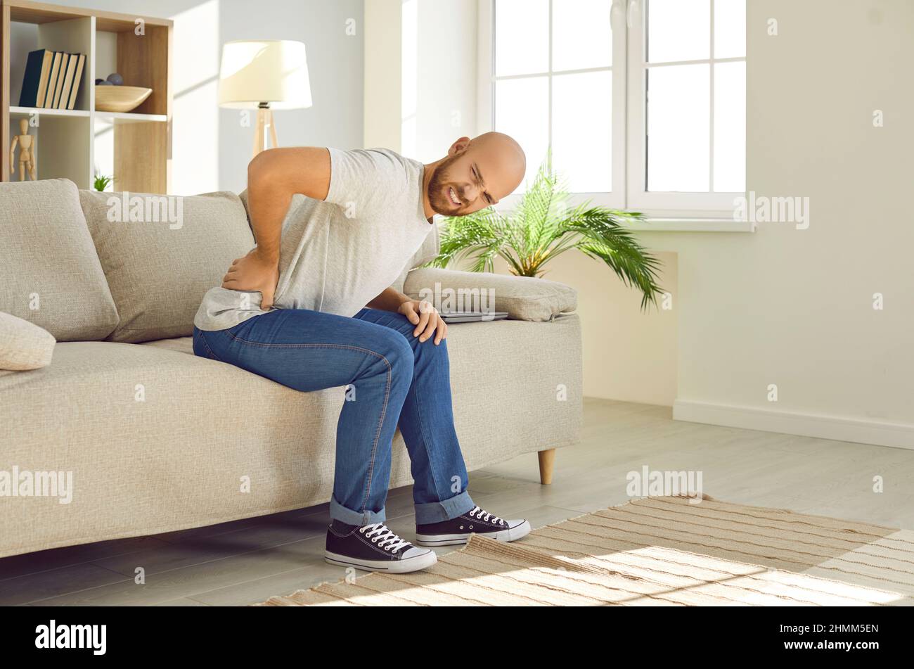 Unwell man suffer from lower back ache Stock Photo