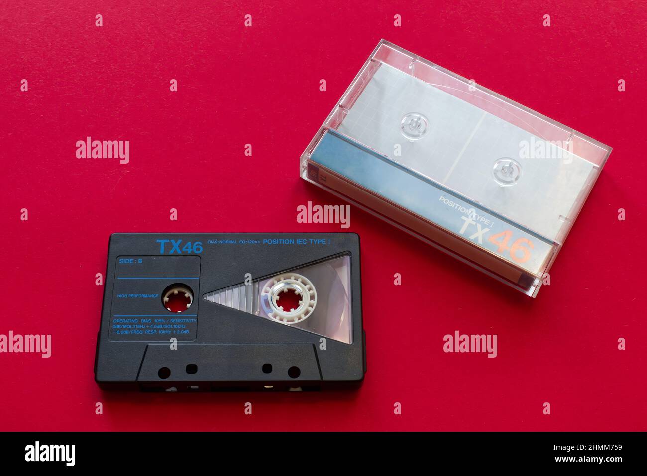 Vintage audio cassette tape and cassette tape case on red background