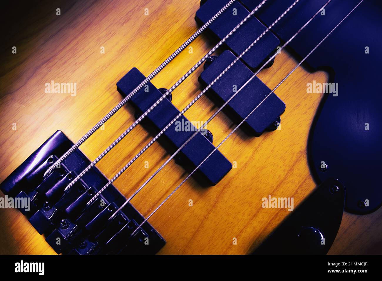 Closeup view of bridge and pickups of five strings bass guitar, highlighted shapes. Stock Photo