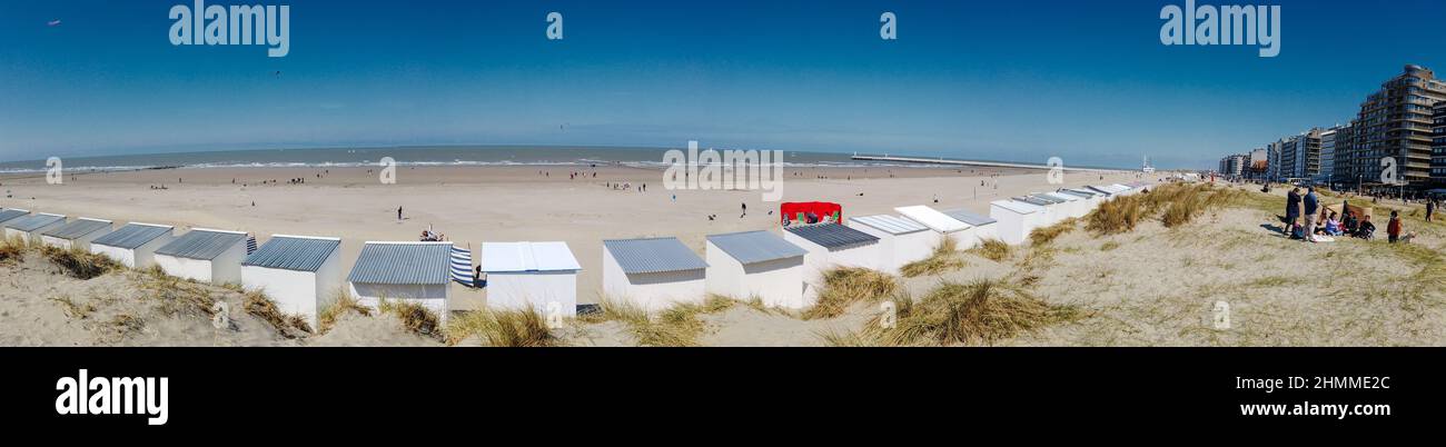 Panoramic view from a dune on the beach of Nieuwpoort with strand cabins in the foreground on a sunny springday Stock Photo