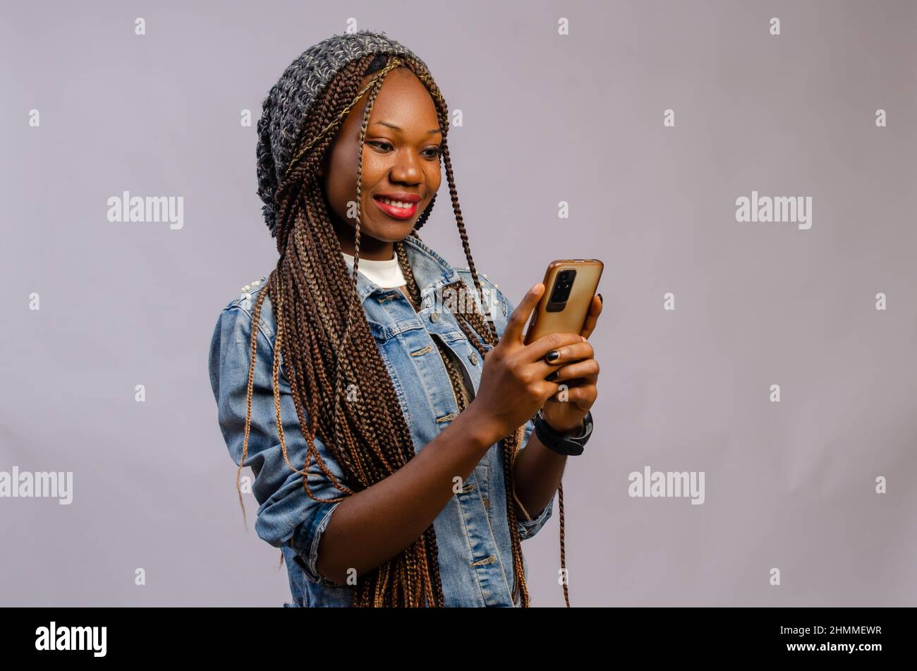 African lady posing smartphone hi-res stock photography and images - Alamy