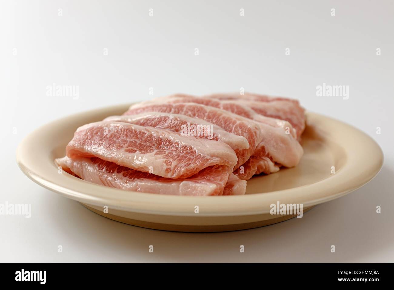 a piece of pork. meat between neck and shoulder. fatty meat cuts Stock