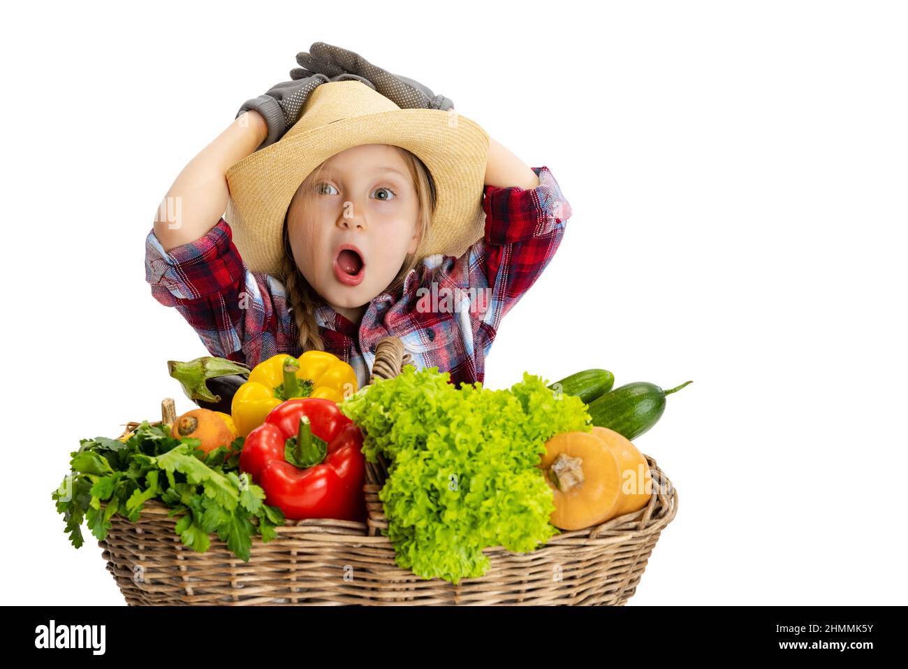 Shocked cute little girl, emotive kid in image of farmer, gardener with ...