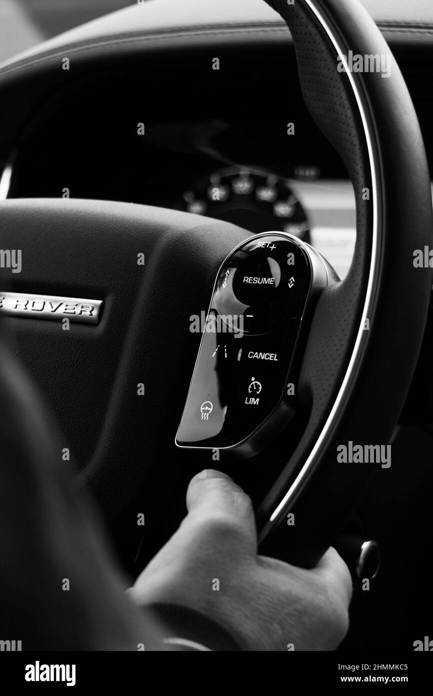 Close-up of hands on the wheel in a range rover car. Stock Photo