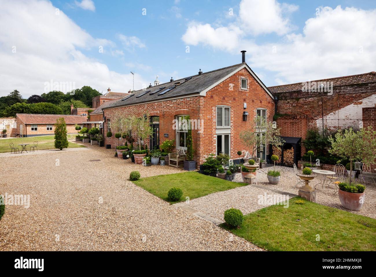 Newport, Essex - July 10 2018: Old farm outbuilding converted into luxurious countryside home within charming landscaped gardens Stock Photo