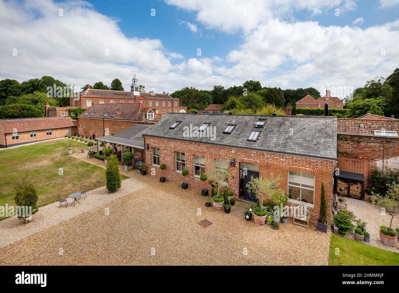 Newport, Essex - July 10 2018: Old outbuilding of country house converted into luxurious brick built home with charming landscaped gardens. Stock Photo