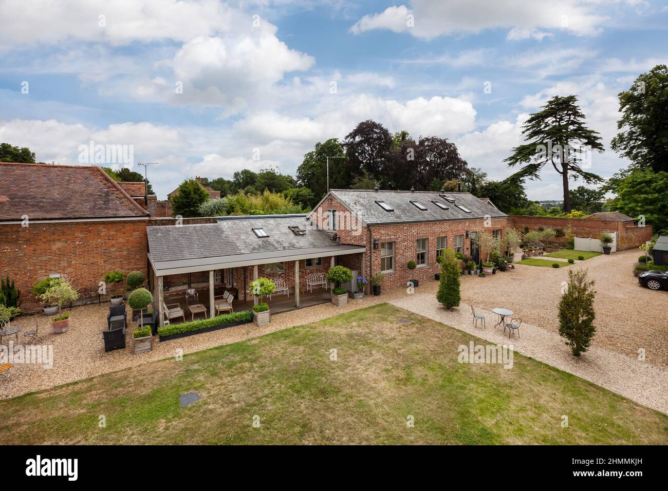 Newport, Essex - July 10 2018: Old farm out building converted into luxurious countryside home within charming landscaped gardens Stock Photo