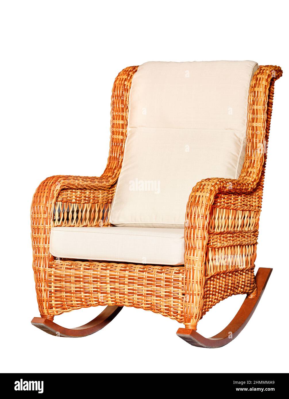 Wicker rocking chair with soft fabric upholstery in beige color isolated on a white background. Stock Photo